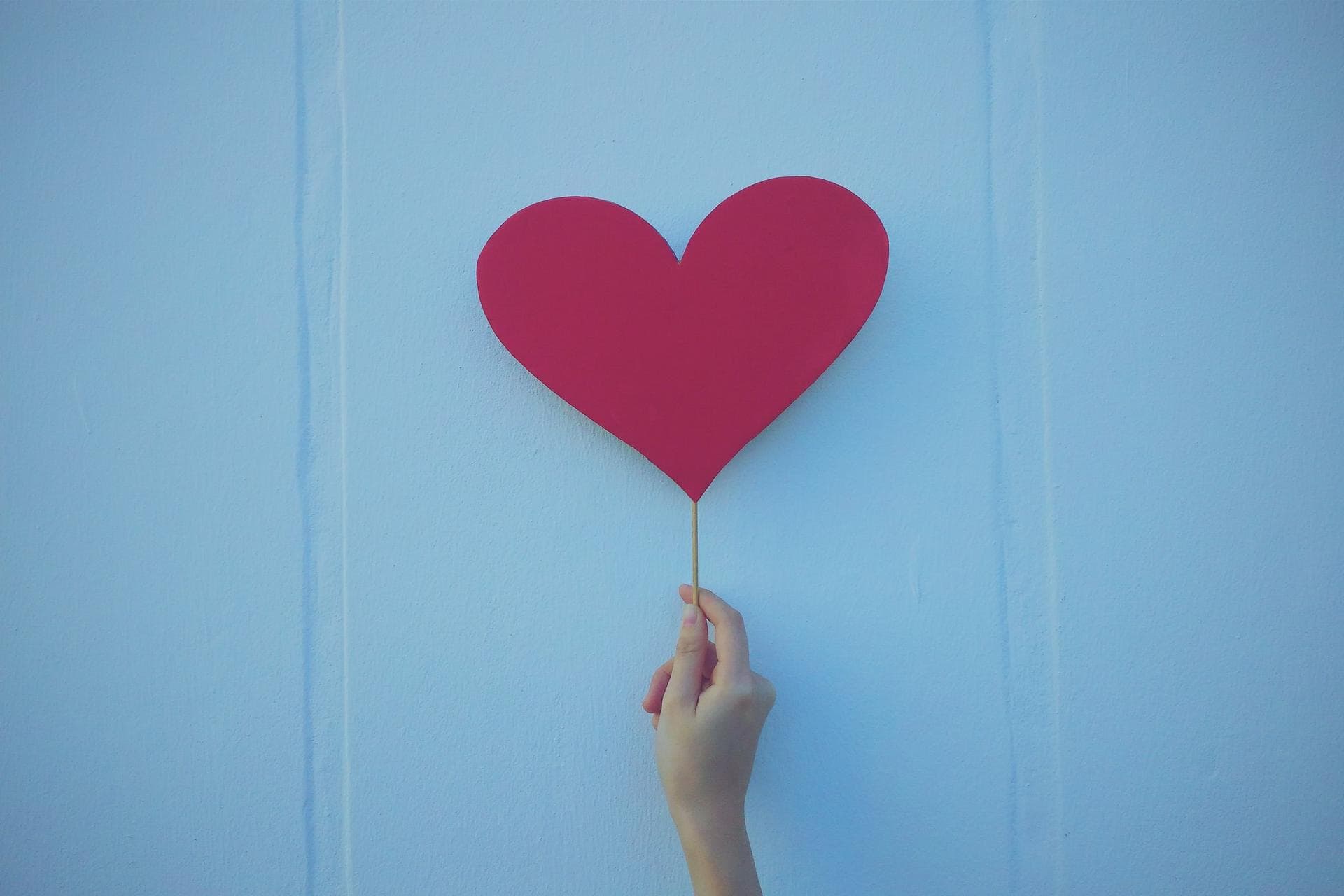 red heart in front of a light blue background